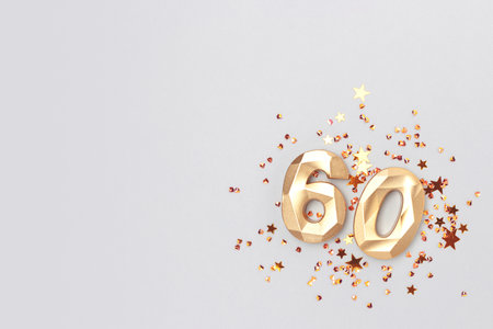 Golden number 60 and shiny stars confetti on a blue background. Festive concept.の写真素材