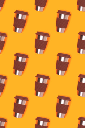 Pattern made of reusable coffee cup on a yellow background. Take away drinks concept.の写真素材