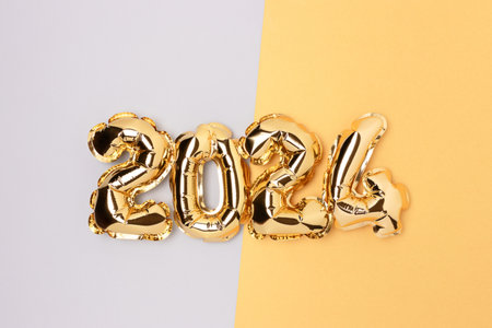 2024 air balloons on a blue and gold background with place for text. New Year festive concept.の写真素材