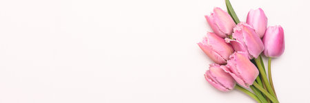 Banner with bouquet of pink tulip flowers on a gray background. Place for text.の写真素材