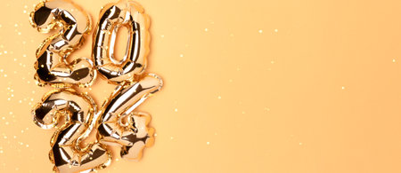 Banner with 2024 foil balloons on a golden background with copy space. New Year composition.の写真素材