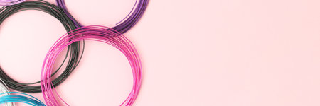 Banner with aluminum wire for jewelry making on a pink background.の写真素材