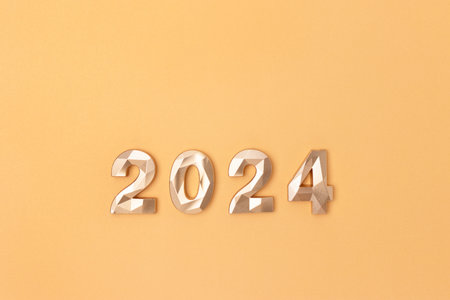 2024 numbers on a gold colored background. New Year minimal concept with place for your design.の写真素材
