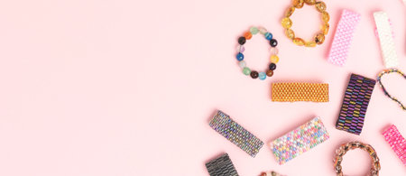 Banner with handmade beaded rings on a pink background. Place for text.