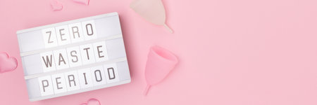 Zero waste period. Banner with lightbox and menstrual cups on a pink background.の写真素材