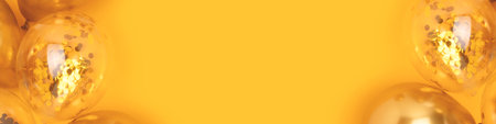 Frame made of golden air balloons with confetti inside on a yellow background. Banner with place for text.の写真素材