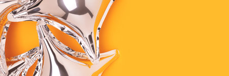 Banner with silver foil star balloons on a yellow background.の写真素材
