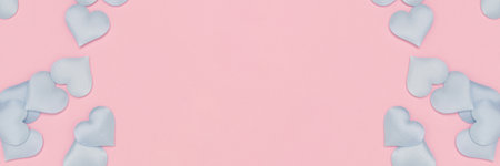 Banner with blue hearts confetti scattered on a pink background. Festive concept.の写真素材