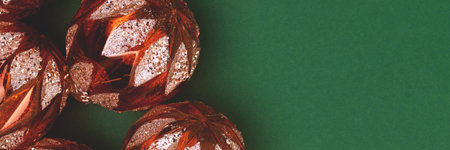 Banner with golden Christmas toys on a green background. Place for text.