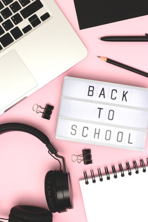 Back to school. Lightbox, headphones, laptop and stationery on a pink background. Online education concept.の写真素材