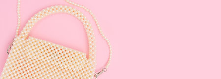 Handbag made from pearl imitation beads on a pink background. Banner with elegance diy accessory.の写真素材