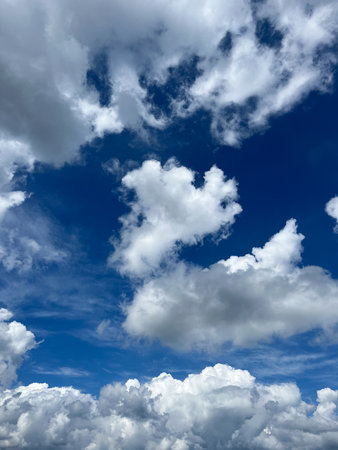 Bright blue sky with big white clouds.