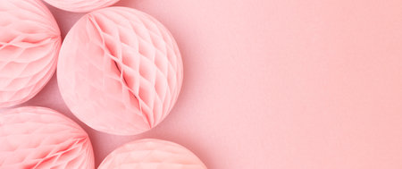 Banner with tissue paper balls on a pink background. Place for text.の写真素材