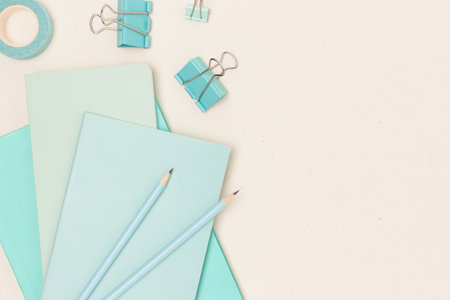 Mint colored school supplies on a beige background. Place for your design.の写真素材
