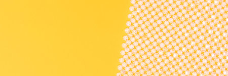 Detail for handbag made from acrylic beads on a yellow background. Banner with copy space.