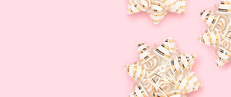 Banner with golden ribbon bows scattered on a pink background.の写真素材