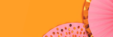 Banner with pink paper fans on a yellow background. Festive concept.の写真素材