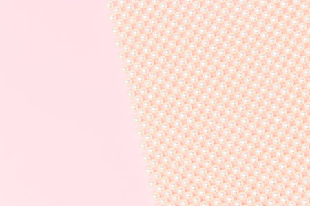 Detail for handmade bag made from pearl imitation beads on a pink background with copy space.の写真素材