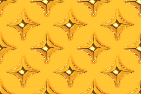 Repetitive pattern made of golden inflatable star balloons on a yellow background. Festive creative layout.の写真素材