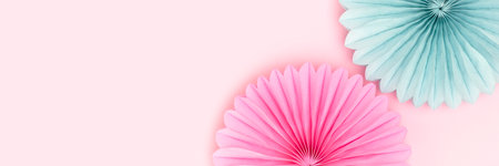 Banner with tissue paper fans in a blue and pink colors. Place for text.の写真素材