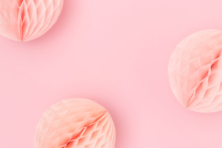 Tissue paper balls on a pink background. Festive concept with copy space.の写真素材