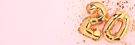 Banner with number twenty golden balloons with confetti on a pink background.の写真素材