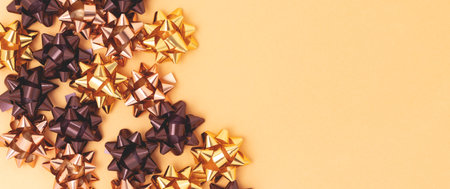 Banner with golden metallic bows made from ribbons.の写真素材