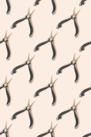 Pattern made of round-nose pliers on a beige background.の写真素材