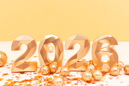 New 2026 Year - numbers and stars confetti in front of beige and golden background. Creative...