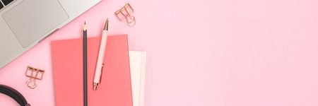 Banner with laptop and office supplies on a pink background.の写真素材