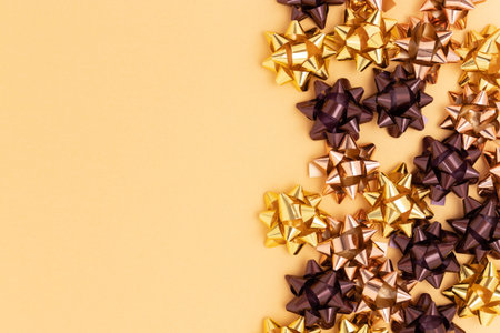 Golden metallic bows made from ribbons. Place for text.