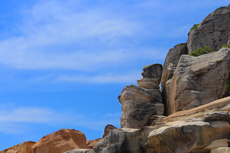 Top of a rocky cliff with a blue skyの写真素材