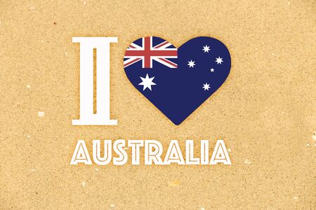 I love Australia graphic on a background of fine golden beach sand - Australian flag in a heart shape - Australia dayの写真素材