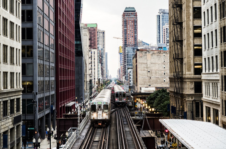 Train on elevated tracks within buildings at the Loop, Chicago City Center - Bleach Bypass Artistic Effect - Chicago, Illinois, USAのeditorial素材