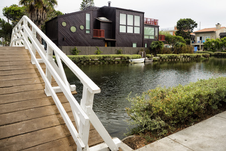 Venice Canals, white bridge and modern architecture house - Venice Beach, Los Angeles, California, USAの写真素材