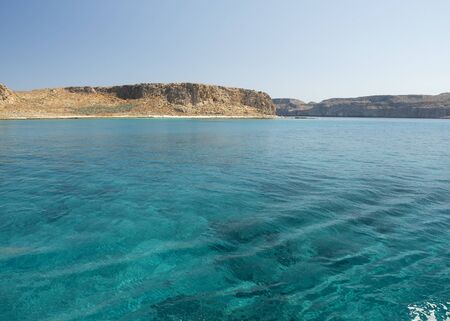 Balos Lagoon Blue sea, hills and boat, transparent water as a swimming pool, Crete Island, Greeceの写真素材