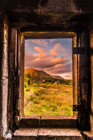A beautiful frame for the countryside. It's framing a tree and the mounts of Etna.の写真素材