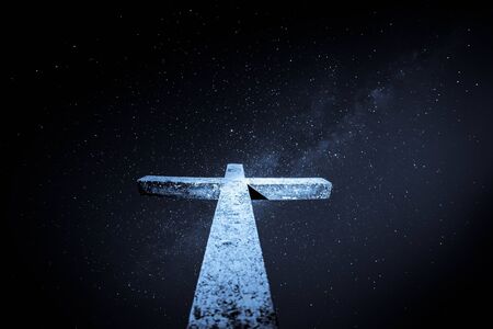 A gloomy Cross That rises high and the starry sky with the Milky Way wonderful view from Mount Rocca Fiorita ME, Sicily, IT.の写真素材
