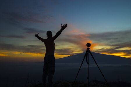 Self portrait. A shot That portrays me in observing my beloved Etna. The wonderful colors of the sunset seen from the Monte Veneretta ME, Sicily, IT. A shot that portrays me in observing my beloved Etna. The wonderful colors of the sunset seen from the Moの写真素材