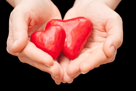 Plasticine heart in hand on a black backgroundの写真素材