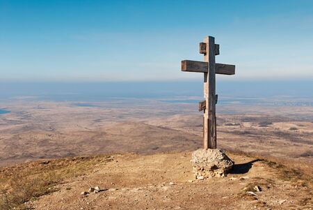 wooden cross on a background of blue skyの写真素材
