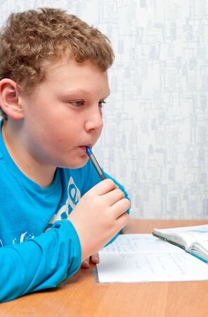 boy doing homework on mathematics in the roomの写真素材