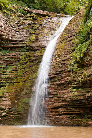 A beautiful waterfall in the summer woodsの写真素材