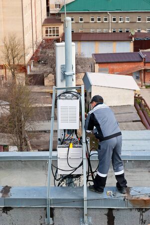 Master repairing cellular base stations at a heightの写真素材