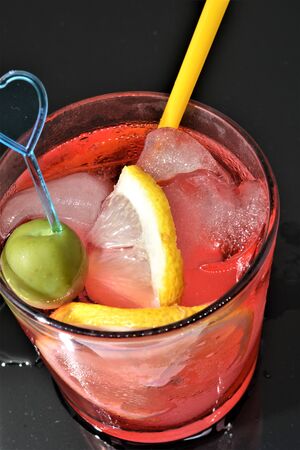 bitter cold aperitif with ice lemon olive red drink italianの写真素材