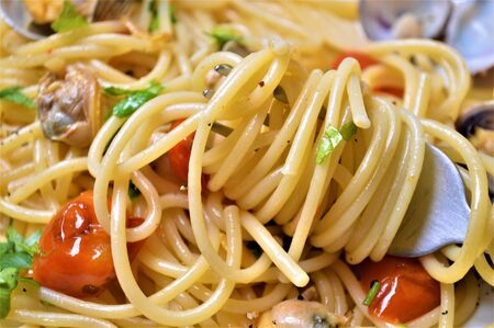 italian spaghetti pasta with clams tomato garlic seafoodの写真素材