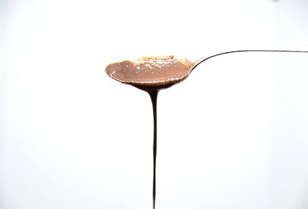 chocolate spoon on white backgroundの写真素材