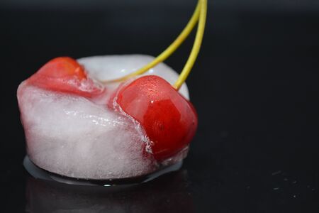 red cherries in ice cubeの写真素材