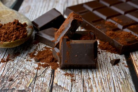 pieces of black chocolate on wooden tableの写真素材