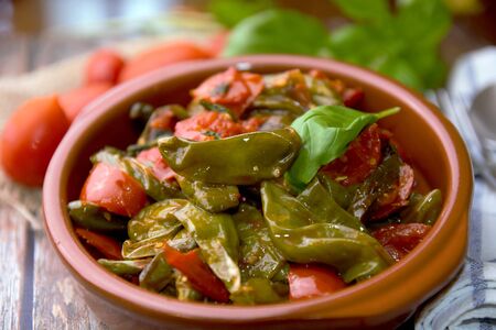 fried green peppers with tomato and basilの写真素材